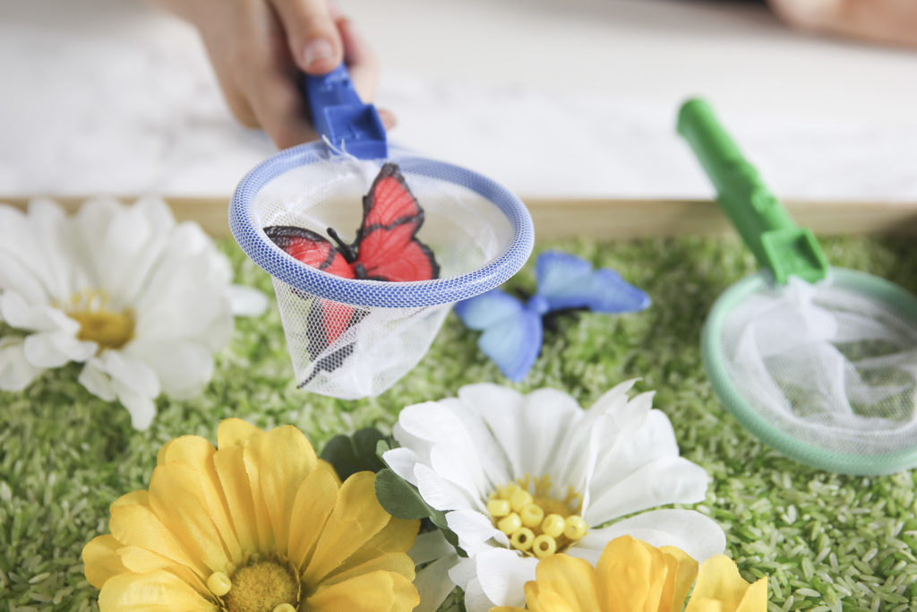 Make a DIY sensory bin filled with flowers and butterflies for spring