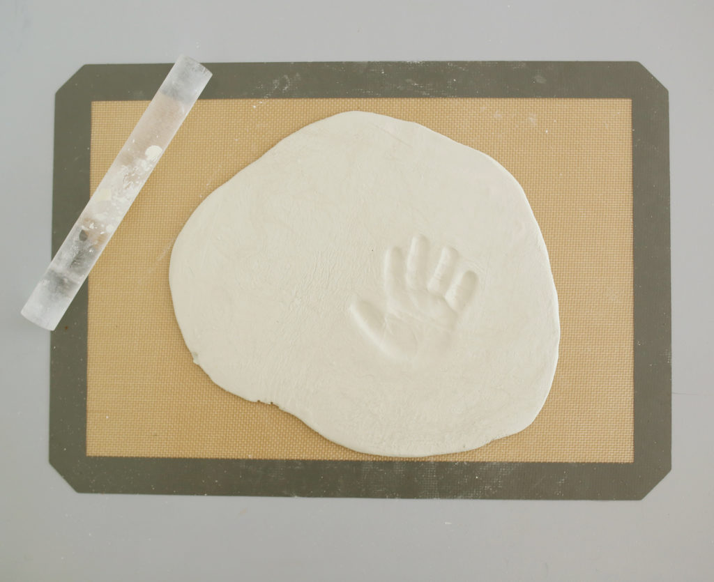 Press your child's hand into clay to make a handprint
